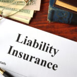 Liability insurance on a wooden table with glasses.